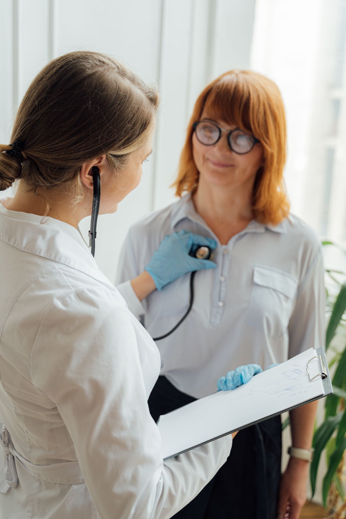 Clinician using a stethoscope during an examination