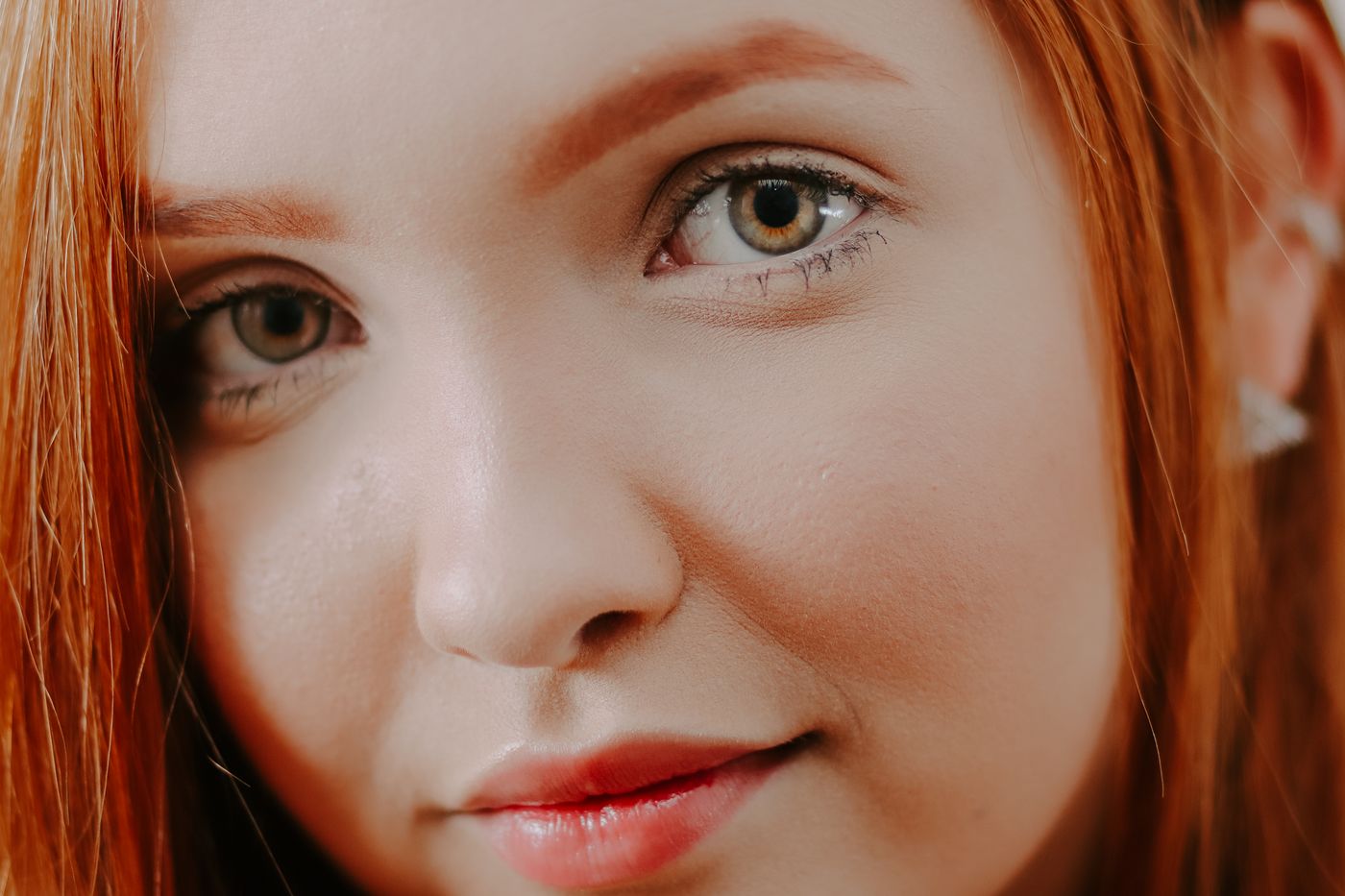 pigmentation treatment Kuala Lumpur – Intimate close-up of a redheaded woman showcasing natural beauty and elegance.